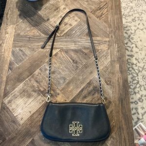 Tory Burch black and gold clutch and crossbody bag.
